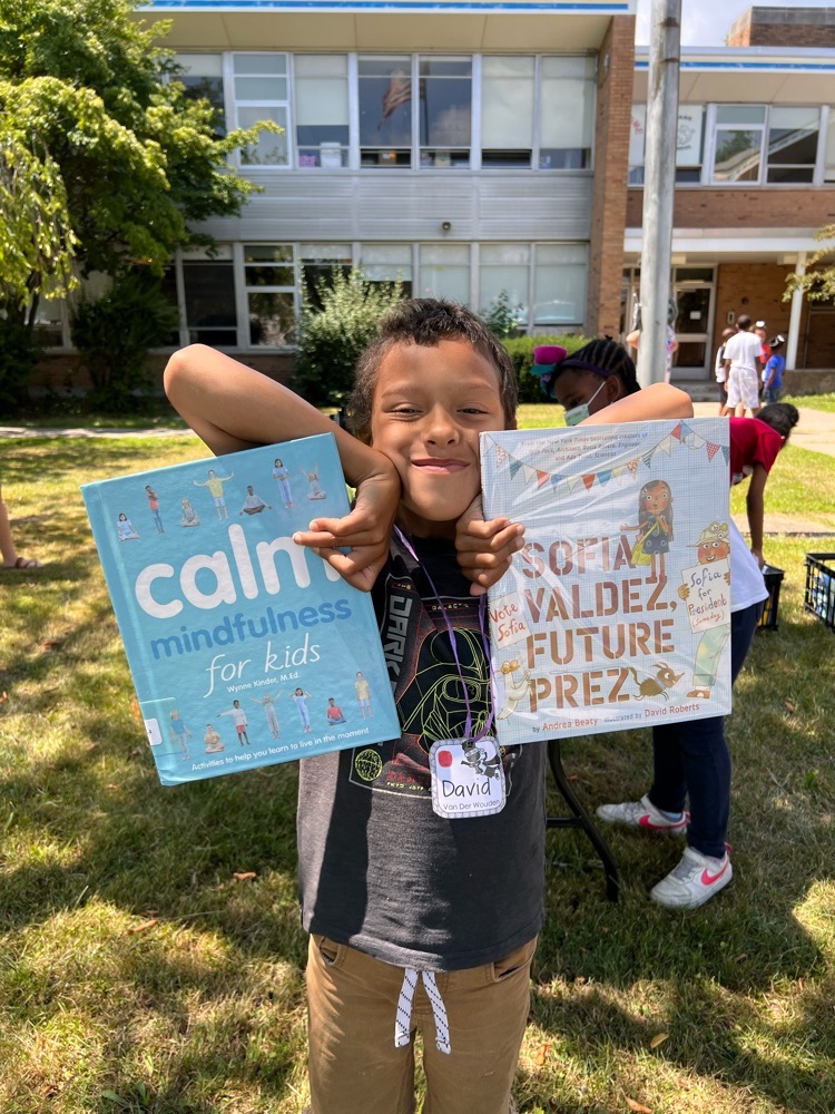 students holds two books