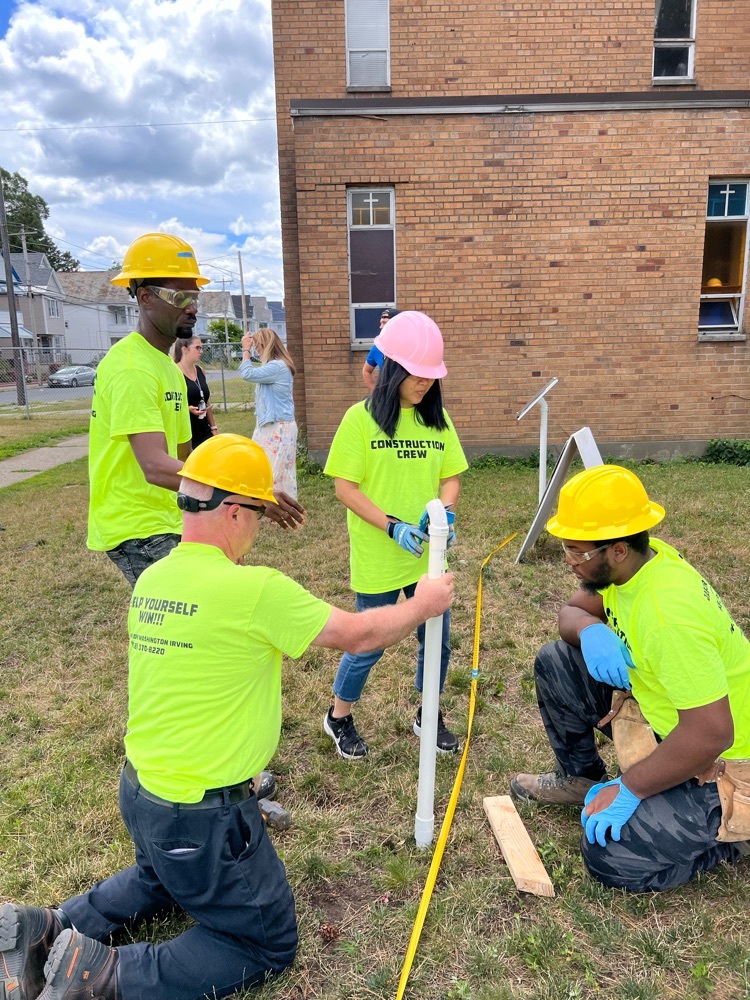 construction crew measures poles