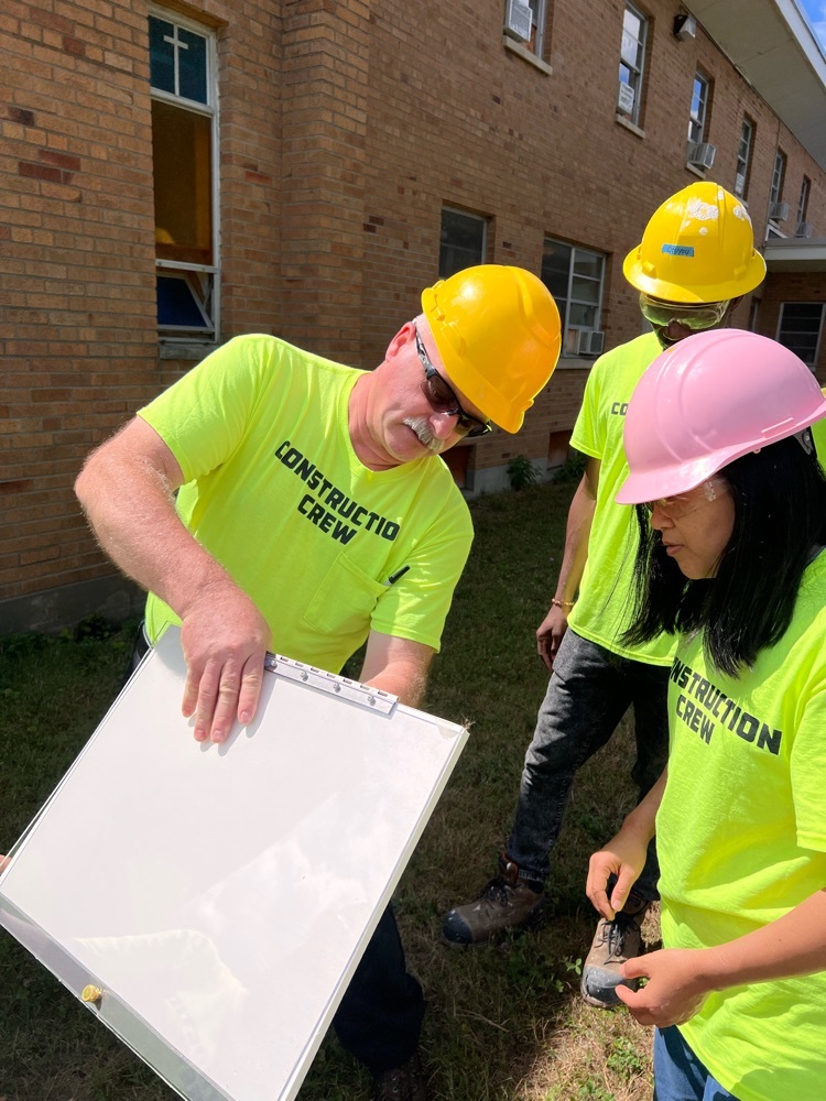 construction teacher and student build sign