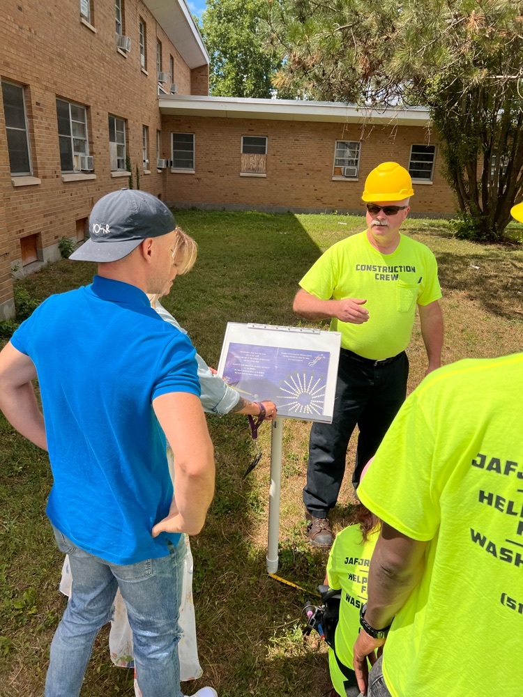 group admires new sign